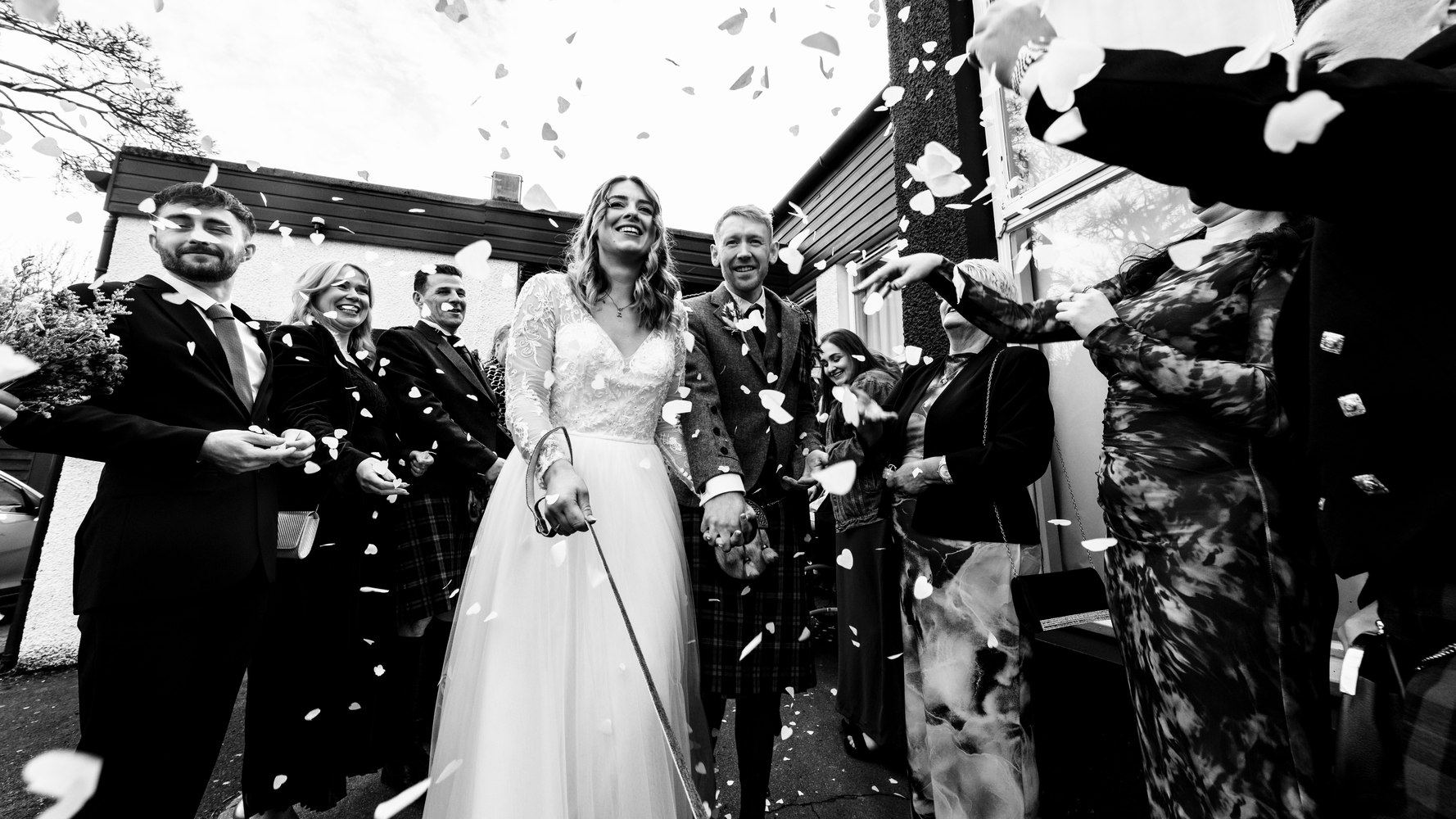 Confetti thrown over the newlyweds as guests cheer