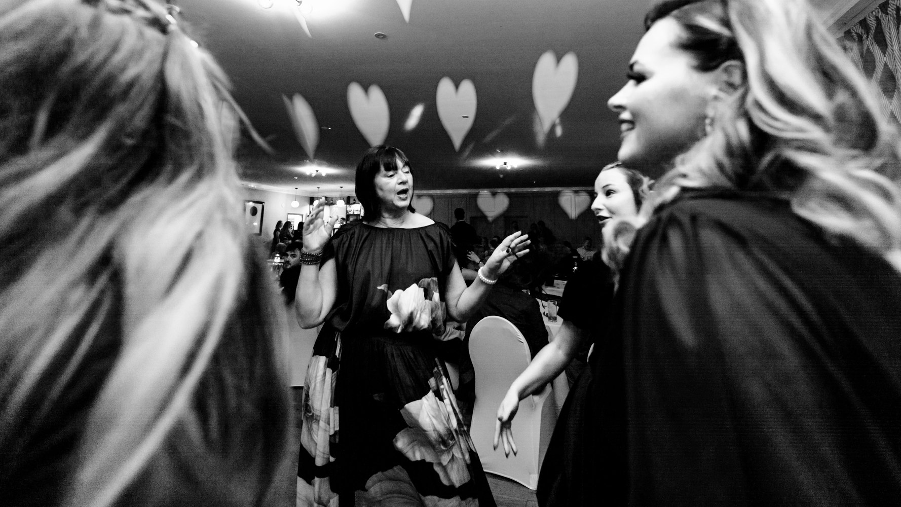 Guests dancing under heart-shaped light projections