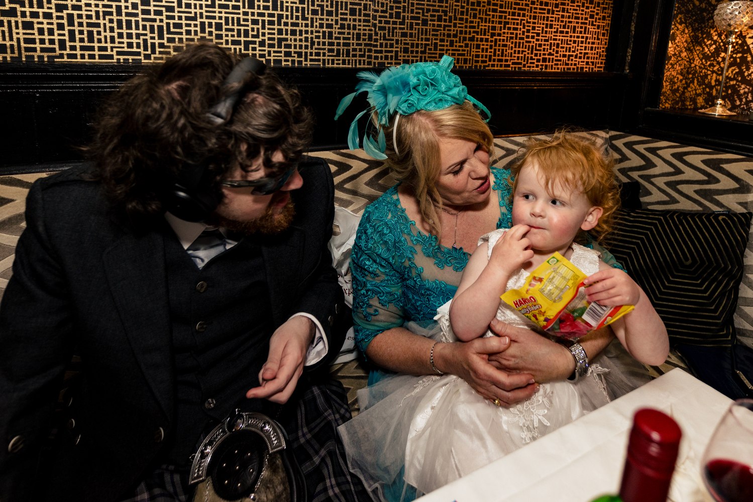 A quiet moment between guests and a child at the reception