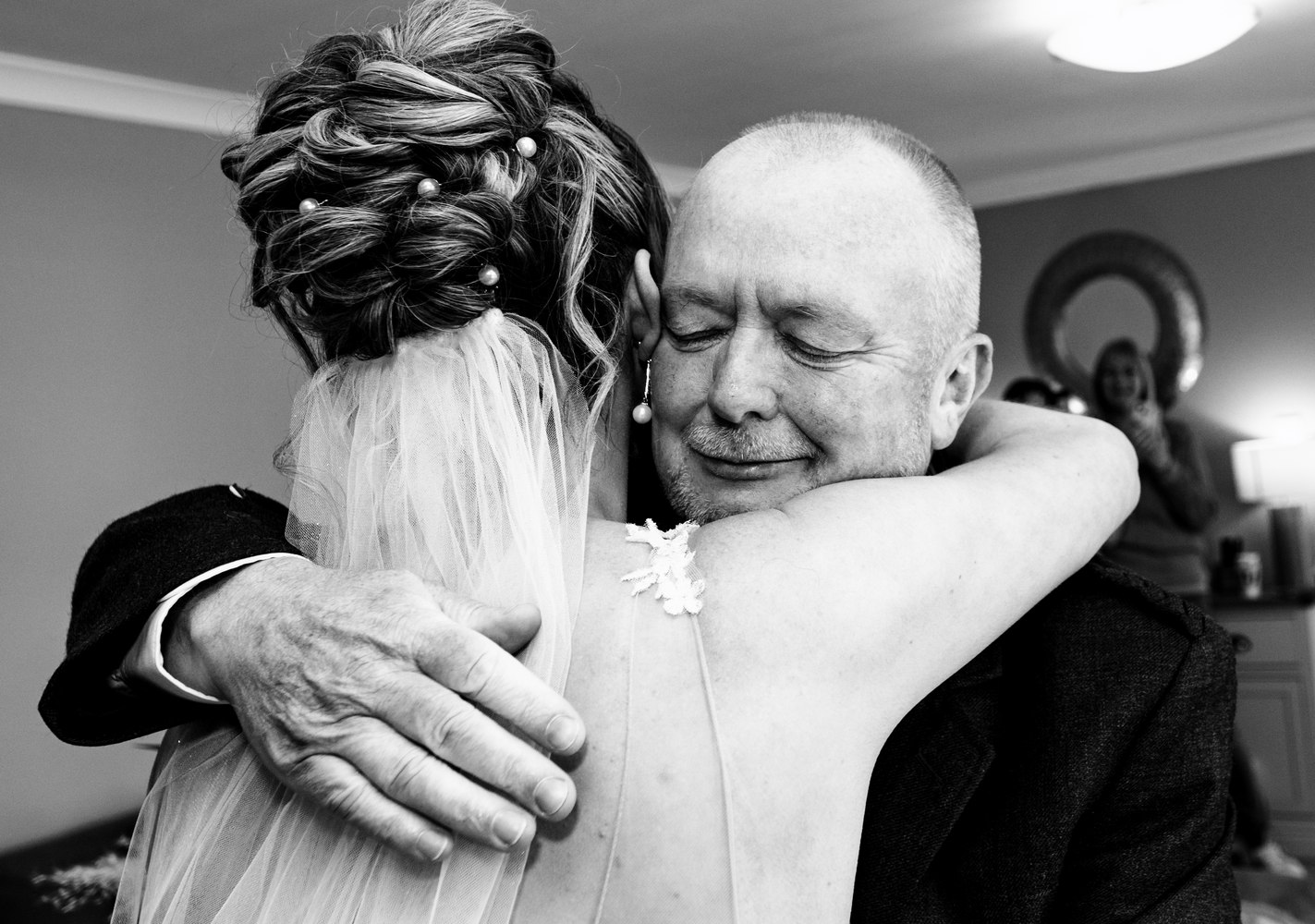 An emotional embrace between the bride and her father