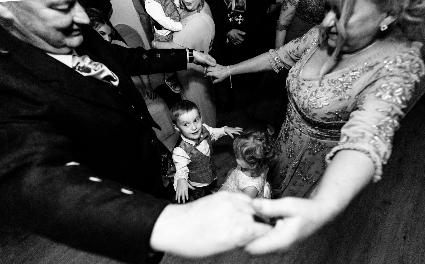 Guests and children joining hands in a circle at the reception