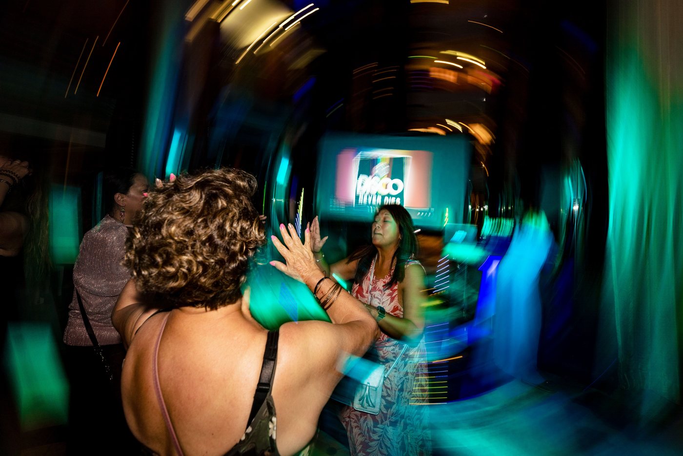 Guests dancing close together, hands in the air